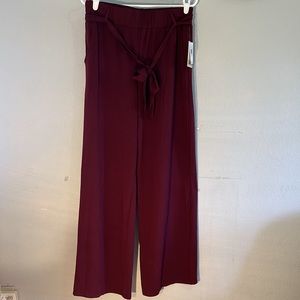 BeBop large pull on belted burgundy wide leg pants has 2 front pockets.